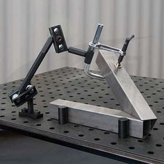 a metal object on top of a table with holes and rivets around it