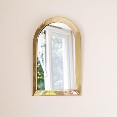 a mirror hanging on the side of a wall