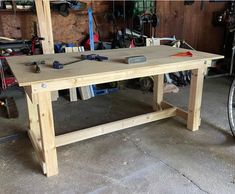 a workbench in a garage with tools on the table and bike parked nearby