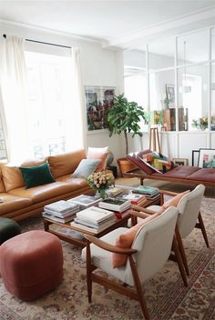 a living room filled with lots of furniture and decor on top of a carpeted floor