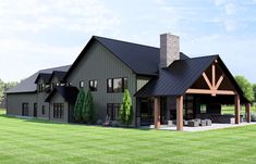 a large house with a covered patio in the grass