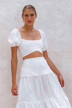 The beautiful 'Blanca' crop top is handcrafted from high quality breathable crinkle linen. Designed with smocked back and stunning fold detailing at the front. Blanca linen top is meant to be worn with the coordinating 'Casablanca' skirt but can easily be styled with your favorite denim or neutral tailoring. Style Blanca crop top with Casablanca Maxi skirt. Features: -Content: 100% Linen-Hand wash cold-Shirred back-Elasticated sleeves-Slip on cropped style-Unlined-This style fits true to size. W Chic Square Neck Crop Top For Beach, White Linen Square Neck Top, Summer Crop Top With Smocked Back And Short Sleeves, Linen Tops With Square Neck For Day Out, Square Neck Linen Tops For Day Out, Cotton Cropped Top For Brunch, White Smocked Bodice Crop Top, Square Neck Crop Top For Spring Vacation, Spring Beach Crop Top With Square Neck