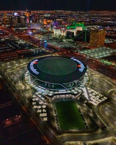 an aerial view of the las vegas stadium at night with lights and buildings in the background