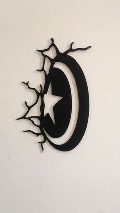 a metal wall hanging with a crescent and star in it's center, on a white wall