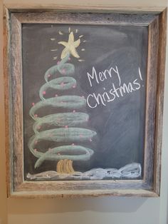 a chalk board with a christmas tree drawn on it