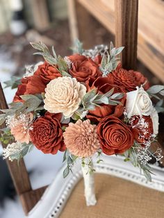 a bouquet of flowers sitting on top of a chair