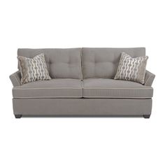 a gray couch with two pillows on it