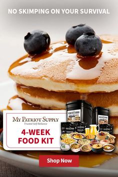 a stack of pancakes with syrup and blueberries on top, next to two packages of yogurt