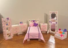 This six-piece fashion doll bedroom set is a one-of-a-kind FirstCraftPick design.  It will delight the fashion doll enthusiast in your life!  This set fits 11 1/2 to 12-inch fashion dolls,  such as Barbie and Ken, as well as 10-inch fashion dolls, such as Skipper.   These pieces are made from 7 count plastic canvas and yarn, plus Poly-fil stuffing to add a little dimension.  The set includes: - a bed with:           * a pink bedspread adorned with purple ribbon           * a rectangular plastic canvas pillow           * 2 plastic canvas heart pillows (1 pink and 1 purple) - a dresser with 4 removable drawers - a nightstand with 2 removable drawers - an etagere with 4 storage shelves - a full-length standing mirror - a 3-tiered shoe rack (Accessories shown in the picture are not included.) Pink Bedspread, Heart Pillows, Canvas Pillow, Purple Ribbon, Purple Heart, Bedroom Furniture Sets, Barbie And Ken, Doll Furniture, Bedroom Set