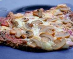 two slices of mushroom pizza on a blue plate