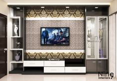 an entertainment center with a flat screen tv mounted on the wall and cabinets below it