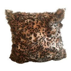 a leopard print pillow with fur on it's back and the top part of its head