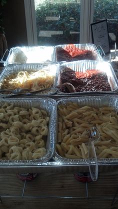 four trays filled with different types of food