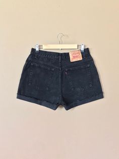 "High waisted 90's denim shorts. Made by Levi's in classic black denim wash. Shorts are in excellent clean condition. Perfectly worn in with light naturally distressed character. These have been cut off and washed once. Measurements are taken zipped or buttoned up and laid comfortably flat then x 2 for total circumference (inches) Tag Size 14 Reg Levis 550 100% Cotton ~Measure Rise First~ Waist 31\" Hips 44\" Length 15\" Inseam 4\" Rise 12\" leg opening circumference 25\" All items are free of r Vintage Short Length Bottoms For Streetwear, Black 90s Style Jeans For Summer, Cutoff Shorts With Belt Loops For Streetwear, Vintage Jean Shorts For Summer Streetwear, Retro High-rise Shorts For Streetwear, Grunge Jean Shorts With Built-in Shorts, Vintage Black Shorts For Summer, Grunge Bottoms With Belt Loops For Summer, Vintage Fitted Cutoff Jean Shorts