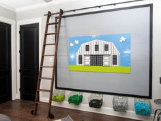 a room with a ladder and pictures on the wall