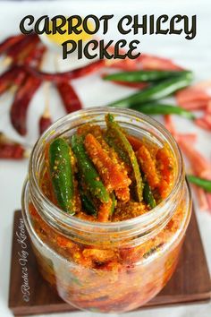 a jar filled with pickles sitting on top of a wooden cutting board