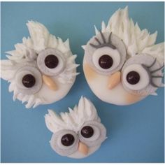 three cupcakes decorated with white frosting and black eyes