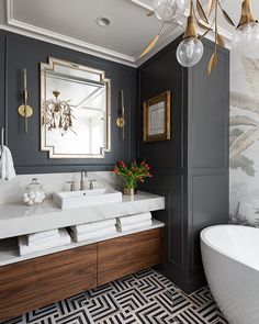 a bathroom with black walls and gold accents