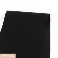 a close up of a black tie on a white background with the words online only