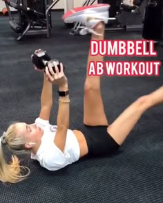 a woman laying on the ground with a tennis racket in her hand and text that reads dumbbell ab workout