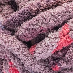 a pile of multicolored blankets sitting next to each other