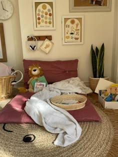 there is a teddy bear sitting on the bed in this room with many pictures above it