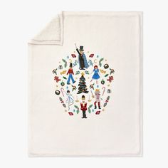 a white blanket with an image of people and christmas trees in the center on it