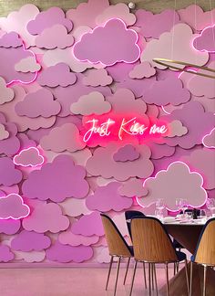 a restaurant with pink clouds on the wall