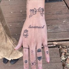 a person's hand with tattoos on it