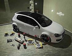 a small white car with tools on the floor