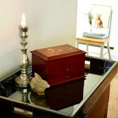 a table topped with two boxes and a candle