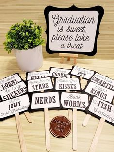 graduation cupcake toppers on wooden sticks with sign and potted plant in background