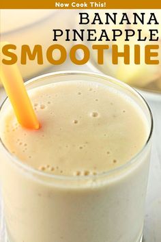 banana pineapple smoothie in a glass with an orange straw sticking out of it