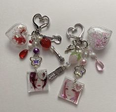 several charms are arranged on a white surface