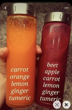 two orange and red water bottles with the words carrot apple lemon ginger tumeric on them