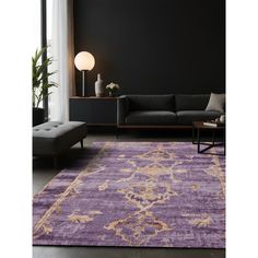 a living room with a purple rug on the floor and a black wall behind it