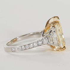 a yellow and white diamond engagement ring