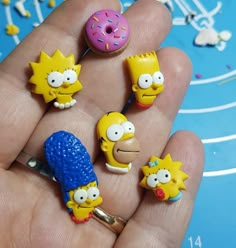 the simpsons characters are being held in their hand with doughnuts and sprinkles