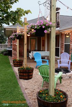 an outdoor patio with chairs and potted plants