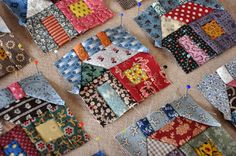 many pieces of colorful fabric are laid out on the floor to be sewn together