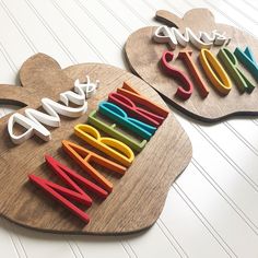 two wooden cutting boards with cut out letters and mickey mouse ears on them that spell out the word disney