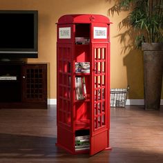 a red phone booth sitting on top of a hard wood floor