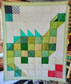 a quilted wall hanging in a room