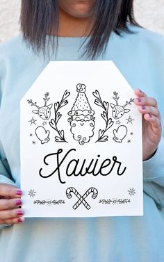 a woman holding up a sign with the word kaver on it in front of her face