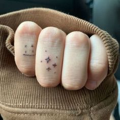 someone has two fingers with small stars on them