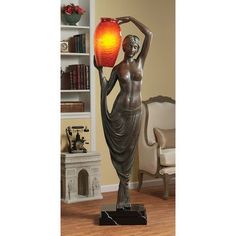 a bronze statue with a red light in it's hand