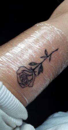 a small rose tattoo on the wrist