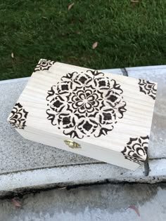 a wooden box sitting on top of a cement slab