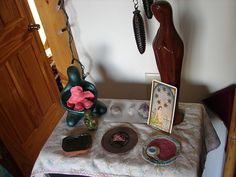 a table topped with lots of assorted items on top of a cloth covered table