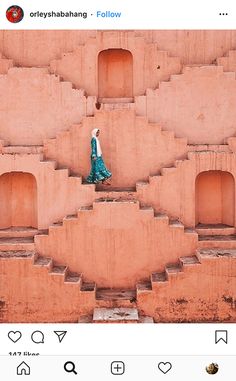 a woman walking up some steps in front of a building with no doors on it